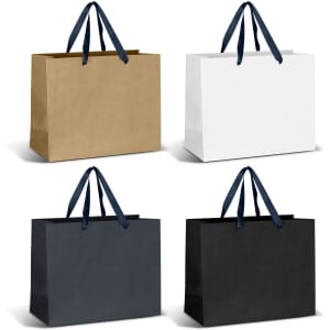 Large ribbon handle paper bags in kraft, white, and black, featuring navy blue handles. Each bag has a plain design.