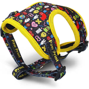 A pet harness featuring a black background with colourful patterns and yellow accents. It has a logo and adjustable straps.