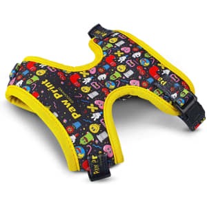 A pet harness in black with colourful patterns and yellow trim, featuring a buckle for secure fastening.