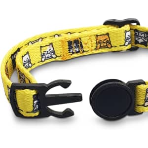 A yellow cat collar featuring various cat patterns and a black clasp, with a solid black adjustable attachment.