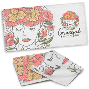 A full-colour beach towel featuring a floral design with red, orange, and green elements. It has a logo present.