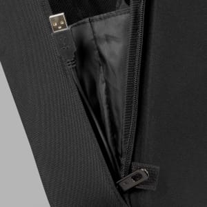 A close-up view of a black backpack's zipper, revealing a USB charging port and inner lining.
