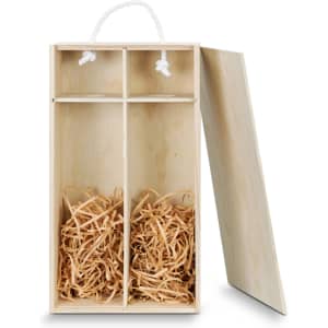 A wooden gift box in natural colour with two compartments filled with shredded paper and a rope handle.