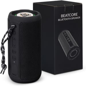 A black Bluetooth speaker with a textured surface and controls, next to a black box featuring its logo.
