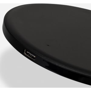 A wireless fast charger in black with a smooth, oval design and a visible USB port.