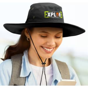 A wide-brim black hat with a logo, featuring a chin strap, worn by a person smiling while holding a phone.
