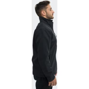 A unisex soft shell jacket in black, featuring a zipped collar and side pockets, worn by a model.