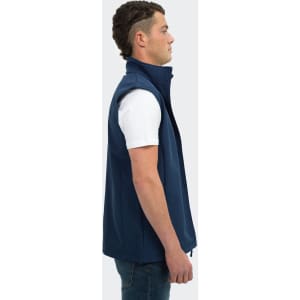 A navy vest for men featuring a high collar and a side zip, displayed on a model in profile.