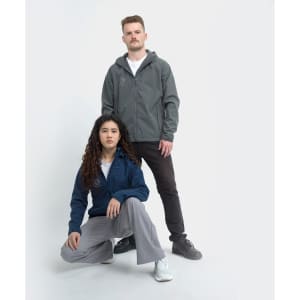 Soft shell jackets in grey and navy, worn by a man and a woman against a plain background. Both feature logos.