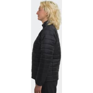 A women's puffer jacket in black, featuring a standing collar and a fitted design, shown from the side.