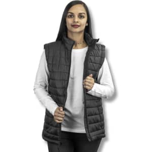 A woman models a black TRENDSWEAR Frazer women's puffer vest, featuring a zip front and high collar.