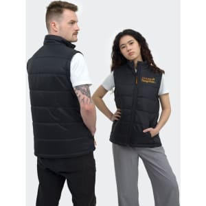 A black puffer vest featuring a logo, worn by models in a minimalist setting.