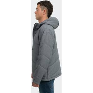 A man models a grey puffer jacket with a hood, featuring quilted design and a logo on the chest.