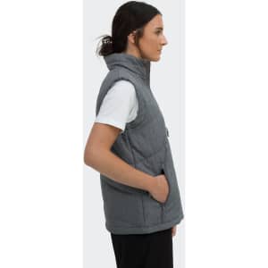 A woman in profile wearing a grey puffer vest with a hood and side pockets. The vest has a logo.