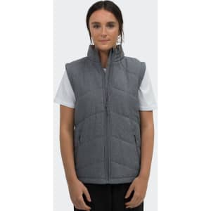 A grey puffer vest with a front zipper and side pockets, worn by a model against a plain background.