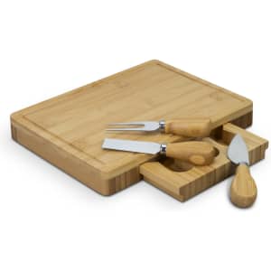 A bamboo cheese board with a rectangular shape and three wooden-handled cheese knives.