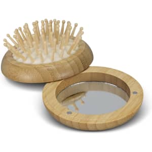 A bamboo brush with wooden bristles and a bamboo mirror, both featuring a natural finish.