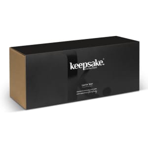 A black and brown box prominently featuring a logo, containing a Keepsake Taster Tray for home use.