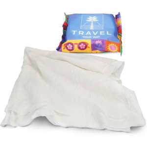 A compressed towel in white, presented in colourful packaging featuring a logo.