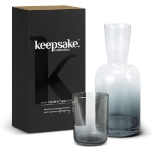 A glass carafe and tumbler set in grey, packaged in a black box with a logo.