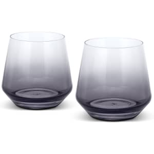 A set of two whiskey glasses in a gradient of clear to dark grey, featuring a modern design and a logo on the base.