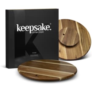 A wooden lazy Susan with a multi-tone finish, presented in a sleek black box featuring a logo.