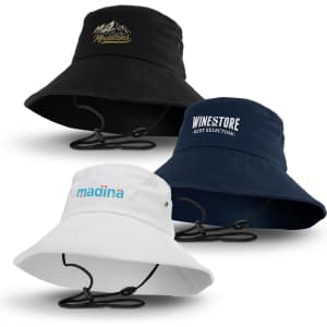 A set of three Yuma bucket hats in black, navy, and white, each featuring distinct logos and adjustable chin straps.