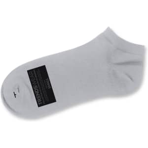 A grey ankle sock made from soft material, featuring a logo and a label indicating size.