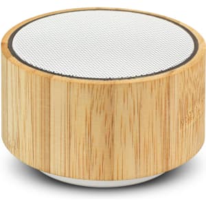 A bamboo Bluetooth speaker with a round design and a white speaker grille on top. It has a natural wood finish.