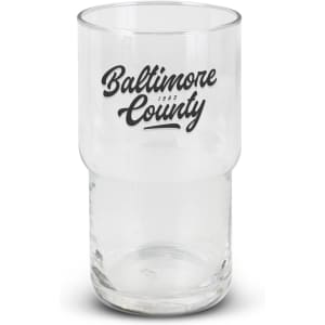 A clear stackable glass tumbler featuring a black logo. The glass has a cylindrical shape with a wider base.