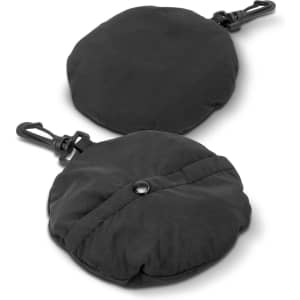 A packable bucket hat in black, displayed in a folded round shape with a clip. Features a logo.