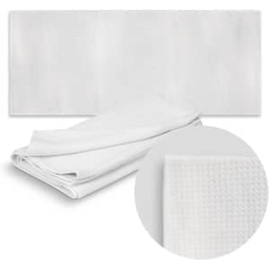 A white sand-free towel displayed flat with a close-up of its textured fabric, featuring a logo.