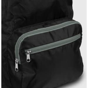 A black foldable backpack with a grey zippered pocket. The material appears lightweight and durable, with a sleek design.