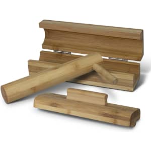 A bamboo sushi maker set featuring a rolling mat, a cylindrical press, and a rectangular holder in natural bamboo tones.