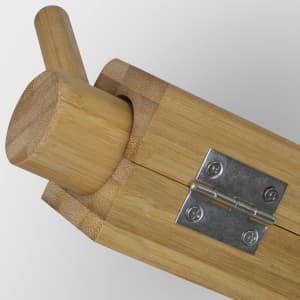 A bamboo sushi maker featuring a cylindrical shape, wooden elements, and a metal hinge.