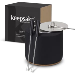 A black keepsake S'mores kit featuring a round container, a lid, and two skewer sticks. The box is also included.