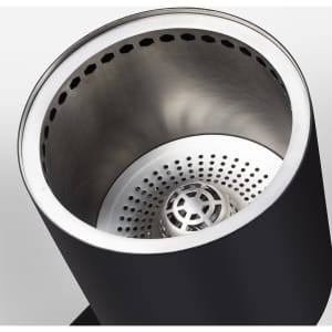 A cylindrical cooker with a black exterior and stainless steel interior, featuring perforations for ventilation.