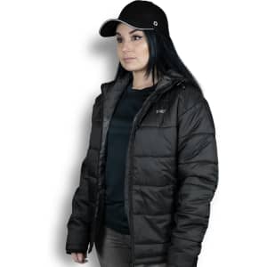 A woman wearing a black puffer jacket with a hood, paired with a black cap. The jacket features logo branding.