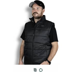 A black puffer vest with a high collar and zip front, worn by a man against a plain background. It features a logo on the chest.
