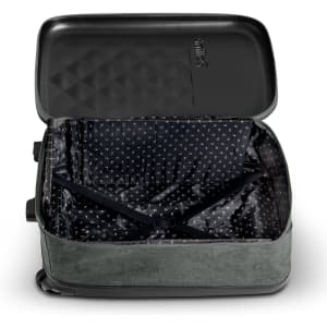 A medium, wheeled suitcase in green with a patterned interior, featuring an open, empty compartment and a logo.