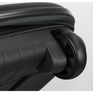 A black wheeled suitcase with a green zipper and a visible wheel assembly. The texture is detailed and sleek.