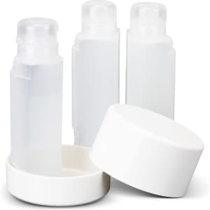 A travel bottle set featuring three clear bottles with white lids and a white base.