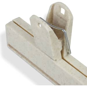 A cream-coloured snack bag clip with a metal spring mechanism for sealing bags. It has two slots and a logo.