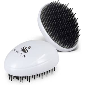 A white hair detangler brush with black bristles, featuring a logo on the lid.