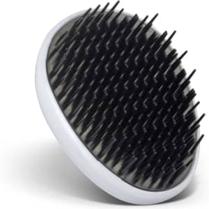 A round hair detangler with black bristles and a white base, designed for easy handling and use.