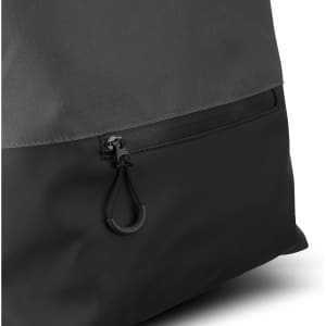 A black backpack featuring a textured grey top and a zipper pocket at the bottom. It has a logo on the side.