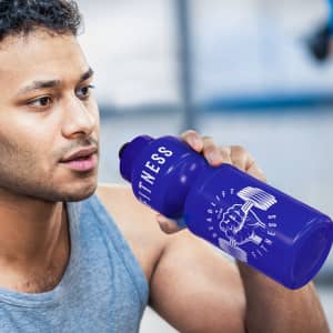 A drink bottle in vibrant purple with a logo, held by a person during a workout.