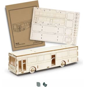 A wooden model bus in natural wood colour accompanied by assembly sheets featuring detailed cutouts.