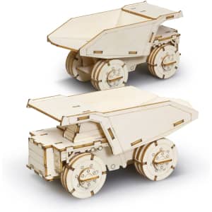 A wooden model of a mining truck, featuring detailed laser-cut designs and a natural wood finish. It has working wheels.