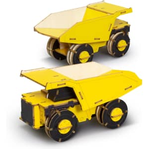 A yellow wooden model of a mining truck with detailed wheels and open top, featuring an engraved logo.